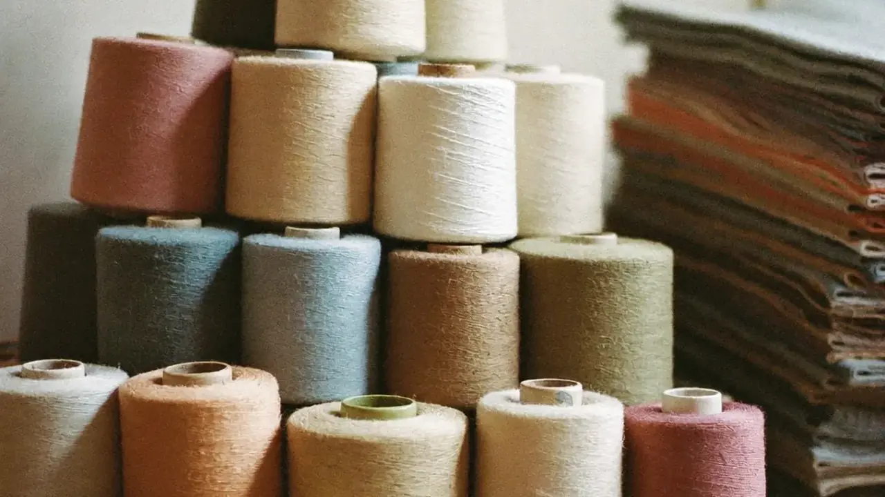 Close texture of cotton thread spools on a rack